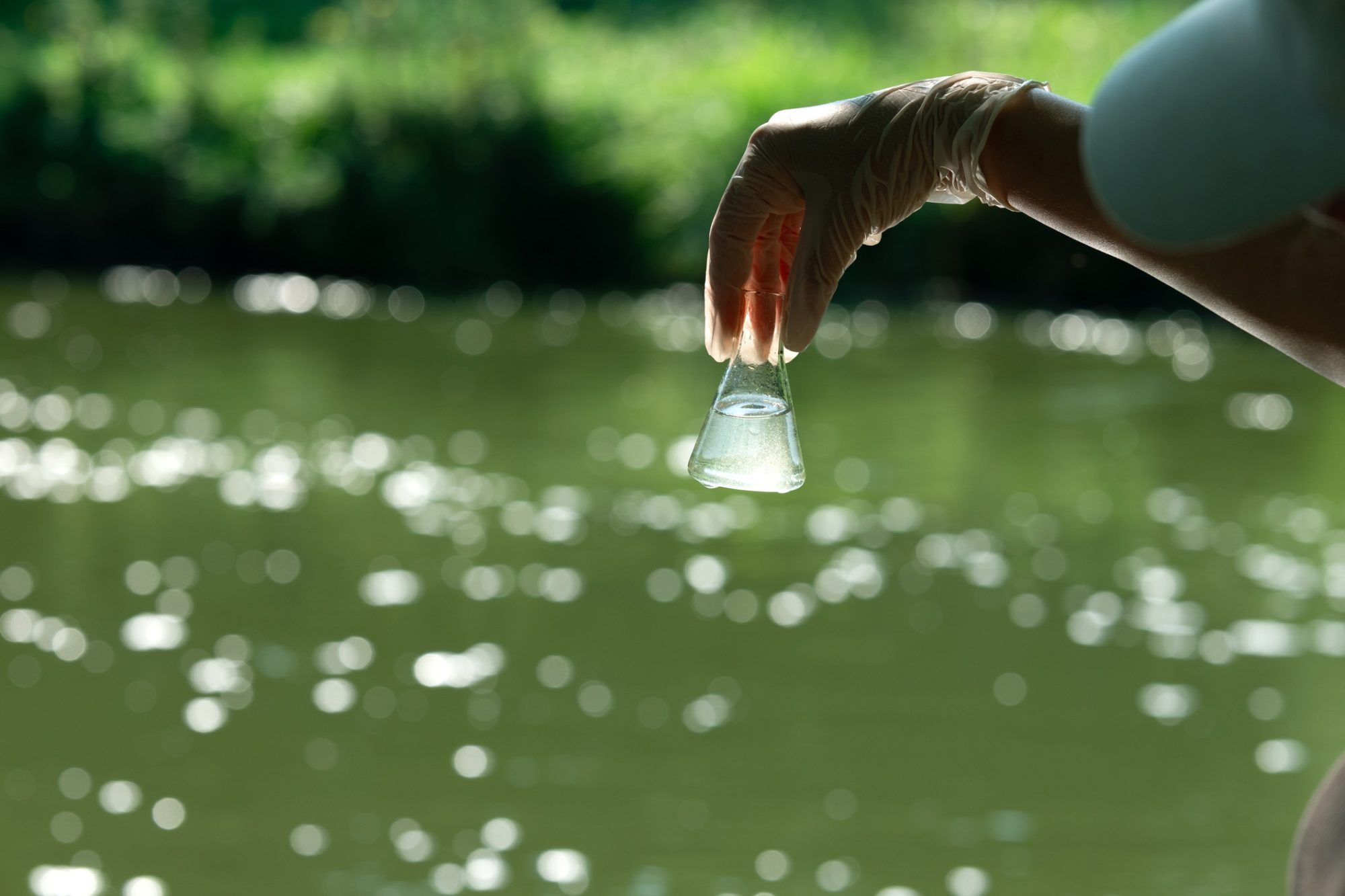 dreamstime_m_316053449 Sampling water for testing. Study of the quality of waste and drinking water. Water analysis.